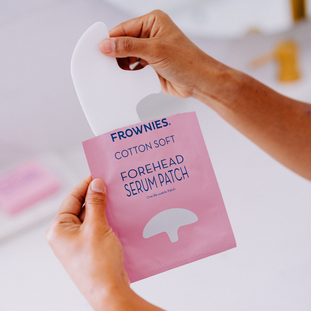 woman's hands removing frownies forehead serum patch for forehead dehydration lines 