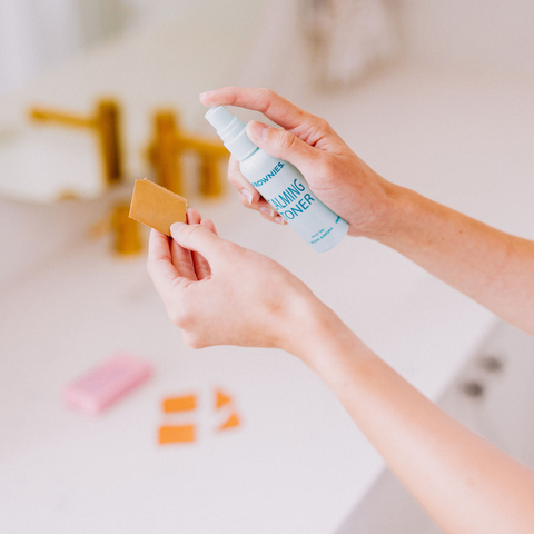 woman's hands spraying Frownies Calming Toner on Frownies Facial Patches