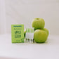 Frownies apple serum pictured next to green apples and showing what the product looks like outside the box