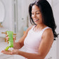 Frownies daily body lotion being squeezed by a woman out onto her own hand 