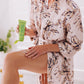 frownies daily body lotion being held and applied to the thigh area of the body. Woman shown rubbing it into her skin