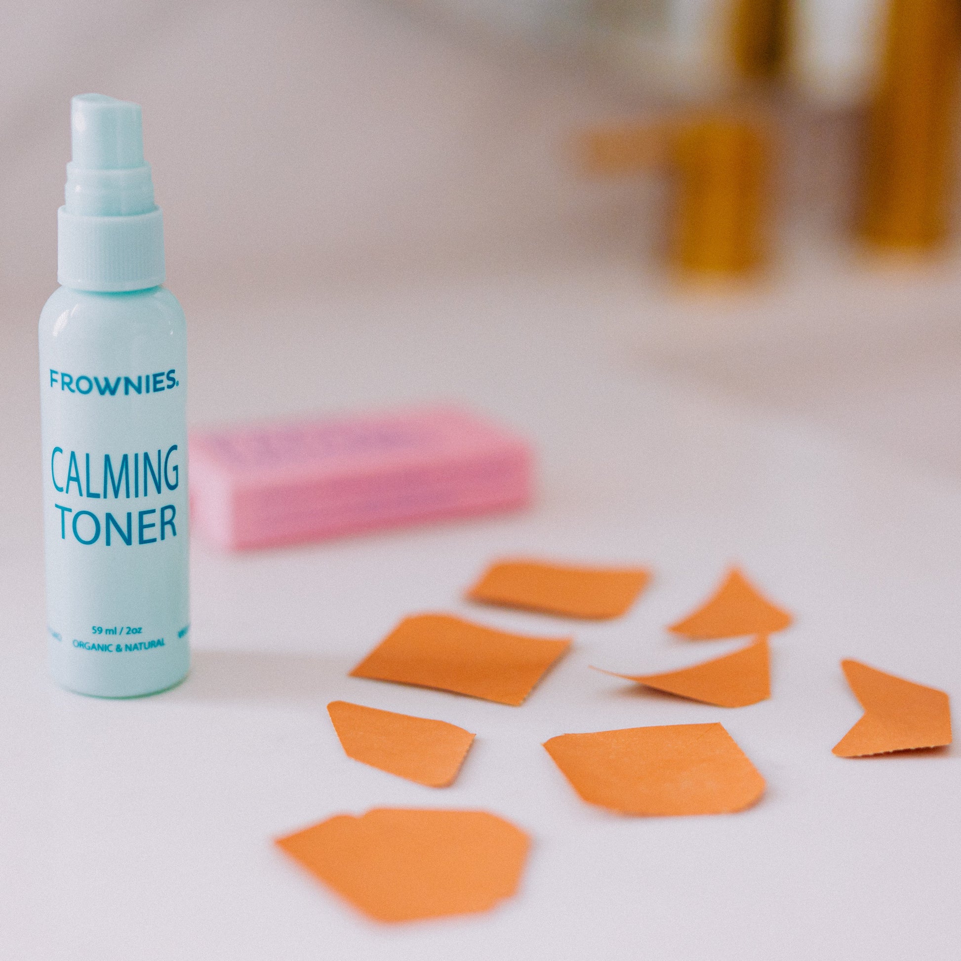 Frownies calming toner pictured along with Frownies facial patches aid out