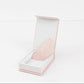Frownies Gua Sha rose quartz shown in its box on a clean white background