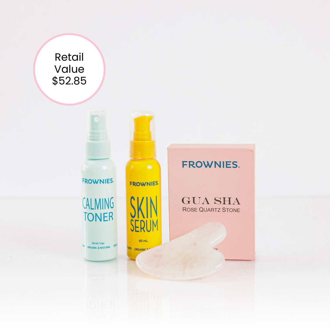 Frownies gua sha rose quartz stone next to Frownies Rose water hydrator spray and skin serum. This is the Gua Sha Bundle. Image shows the retail value of $52.85 showcasing the discount value of purchasing as a bundle. 