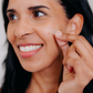 African american woman applying Frownies Pimple Patches near her face