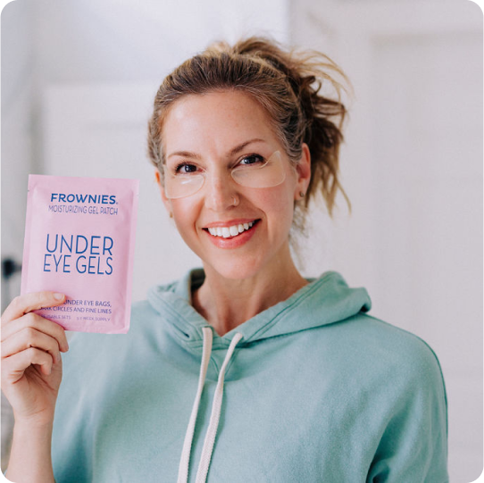 woman wearing eye gels and holding up their packaging 
