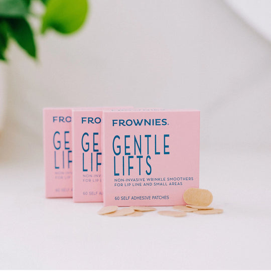 Three boxes of Frownies Gentle Lifts displayed with the patches laid out outside of the packaging.