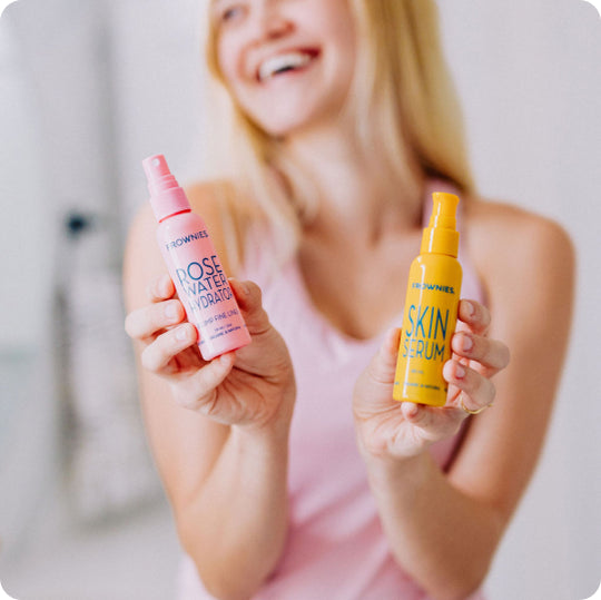 woman holding rose water spray and skin serum
