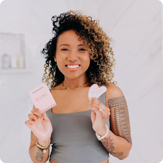 woman_holding_up_frownies_gua_sha