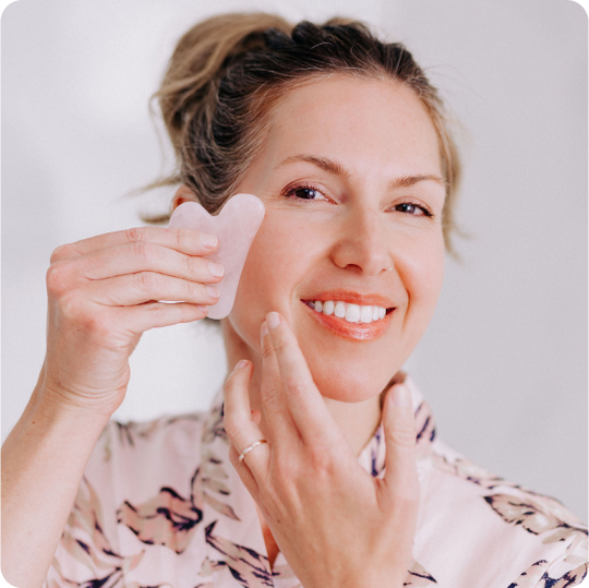 woman_using_rose_quartz_gua_sha